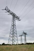 Three pillars of high voltage power lines in Mecklenburg-Vorpommern, Germany. photo