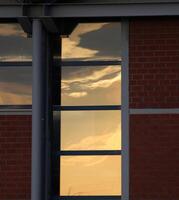 Windows with orange and blue reflection of sky in the evening. photo