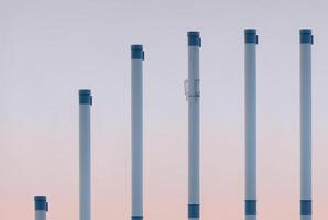 Smoke pipes in ascending row showing saturation curve. photo
