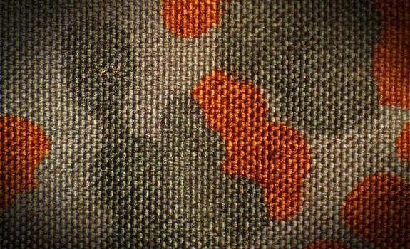 Surface of military camouflage fabric with vignetting and saturated colors photo