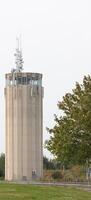 Concrete tower with antennas for telecommunication. photo