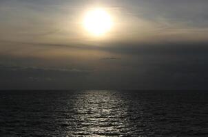 Misty sun over the open sea photo