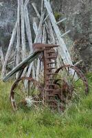 Old-fashioned and rusty agricultural device. photo