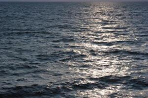 Reflections of the sun on the sea photo