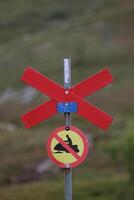 Ski trail marking in Sweden with snowmobile prohibition sign. photo