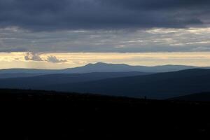 Different shades of blue with cloud formations seen from a swedish mountain. photo