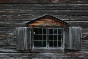 Dark wooden texture of log cabin with old window photo