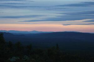 Different shades of blue and orange seen from a Swedish mountain. photo