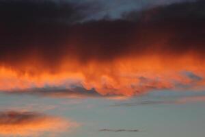 Burning orange cloud in sunset. photo