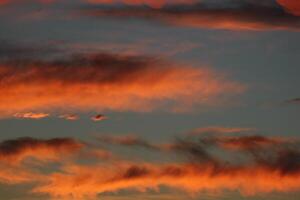 Burning orange cloud in sunset photo