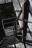 Looking down on steep and rusty ladder steps. photo