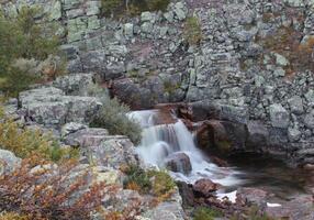 Rapids at the top of the Njupeskaer waterfall in the Fulufjaellet National Park in Dalarna, Sweden. The image was shot with long exposure resulting in smooth water photo