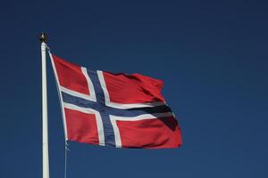 Flag of Norway on dark blue sky. photo