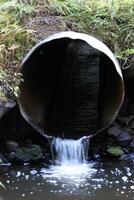 Water pipe in a stream. photo