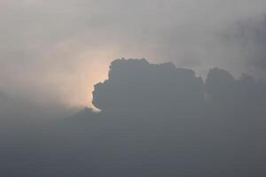 Sun glowing behing cloudscape. photo
