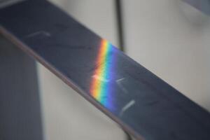 Iridescent reflection on a metal rail. photo