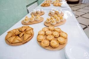 A wide variety of elegantly arranged and artistically presented food items on the beautifully set table looks enticing, delicious, and appetizing for everyone to enjoy and savor photo