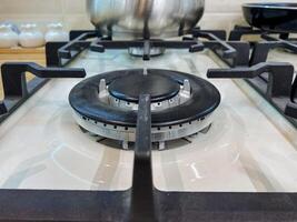 A pot is sitting calmly on a gas stove, which is a fundamental kitchen appliance created specifically for the purpose of cooking food by utilizing gas as the heat source to prepare meals photo