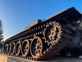 A tank equipped with numerous gears positioned on it, showcasing the intricate engineering involved in its design and functionality, thereby enhancing its overall performance photo