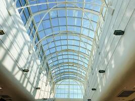 Under the stunning glass ceiling, I am captivated by the intricate architecture that reflects the vibrant urban landscape, enhancing the elegance of the entire metropolitan area photo