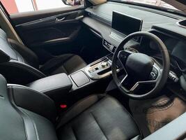 The vehicle interior includes key components like the steering wheel and dashboard, which enhance control and improve the driving experience and comfort for both drivers and passengers photo