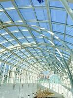The buildings interior is beautifully designed with a large glass roof that fills the space with natural light, creating a bright and welcoming atmosphere for all visitors photo