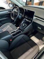 The interior design of a modern car featuring a sleek tablet conveniently positioned on the dashboard, enhancing the overall technological experience for the driver and passengers photo