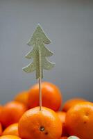 Bright and Festive Decor Featuring Oranges Paired with a Sparkling Glittery Christmas Tree Topper to Create an Enthusiastic and Joyful Ambiance for the Holiday Season photo