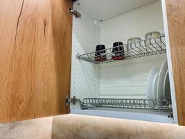 This elegantly designed kitchen cabinet features an integrated dish drying rack for excellent functionality and convenience, making dish drying a seamless task in your home photo