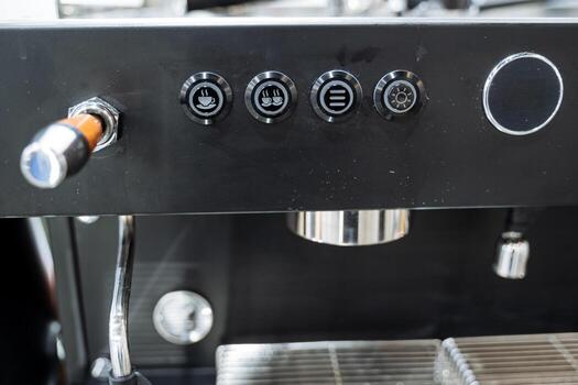 This image showcases a detailed closeup view of a coffee machine, prominently featuring its various buttons and controls, designed for making delicious coffee at home or in the office photo