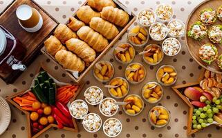 A vibrant array of delicious food on a beautifully arranged table, showcasing varied cuisines and delectable dishes that will delight your taste buds and tantalize your senses photo