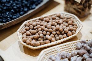 The beautifully arranged dining table features a vibrant selection of nutritious and tasty nuts in stylish baskets, offering a delightful variety of healthy snacks for all to enjoy photo