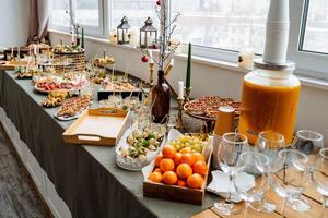 A beautifully arranged buffet table that showcases a diverse assortment of delectable food items along with an impressive selection of beverages elegantly displayed on it for all to enjoy photo