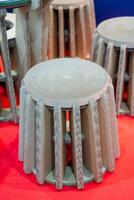 A creatively arranged set of colorful cardboard stools on a vibrant red carpet captures attention, making the room feel lively, energetic, and welcoming to all who enter photo