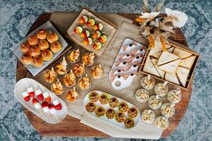 On the table, there are indeed many diverse and assorted types of food available for everyone to enjoy and explore, showcasing a variety of flavors and culinary traditions photo