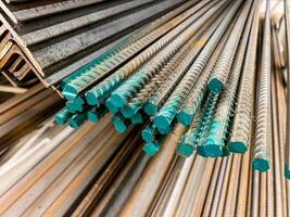 A considerable number of steel bars are meticulously stacked on top of one another, creating a structured arrangement that is often used in construction and engineering projects photo