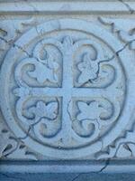 This is a fascinating stone carving featuring a distinct circular shape that is adorned with four beautifully designed hearts located within it, creating an intriguing design photo