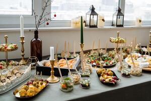 On the dining table, there is a wide variety of different types of delicious food items that are available for everyone to enjoy and savor the experience together as a group photo