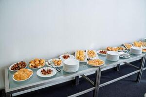A beautifully arranged table is elegantly set with an array of delicious food, inviting everyone to gather around and share in the joy and warmth of a wonderful meal together photo