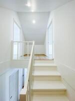Imagine a long, spacious hallway featuring a stunning staircase that leads to the second floor, exuding elegance and showcasing intricate design details of this remarkable building photo