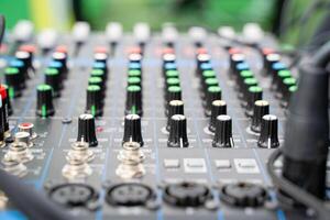 Here is a detailed close up of a mixer featuring numerous knobs and buttons photo
