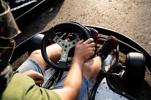 An experienced driver skillfully navigates a gokart on a winding road, enjoying the thrill of control and speed while maintaining balance through the challenging course photo