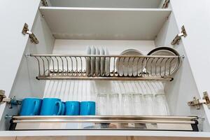 Organized Kitchen Cabinet with Plates and Mugs A Stylish and Neat Storage Solution That Enhances Your Kitchens Aesthetic Appeal and Increases Functional Efficiency photo