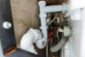 This image features a detailed closeup view of a sink pipe within a bathroom setting, showcasing the intricate design and mechanisms that ensure proper drainage functionality photo