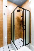 A welldesigned bathroom features a modern shower stall along with a toilet, which together create a functional and convenient space perfectly tailored for daily personal hygiene routines photo