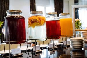 A visually appealing display of refreshing beverages featuring a variety of infused drinks elegantly arranged at a modern buffet setup photo