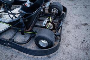 A gokart is currently parked on the side of the road, resting quietly on its wheels, showcasing its unique design and features, capturing the attention of passersby and enthusiasts alike photo