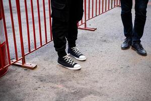 Casual Footwear Choices Seen at a Public Event Where Barricades Were Set Up for Crowd Control and Safety photo