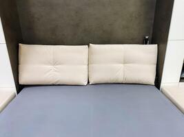 There is a cozy bed that features two pristine white pillows resting comfortably on it along with a vibrant blue mattress, creating an inviting and serene atmosphere in the bedroom photo