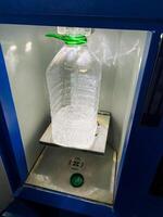 A waterfilled bottle sitting prominently on a machine emphasizes the essential and practical role of drinkware in our daily routine, ensuring convenient access to hydration whenever needed photo